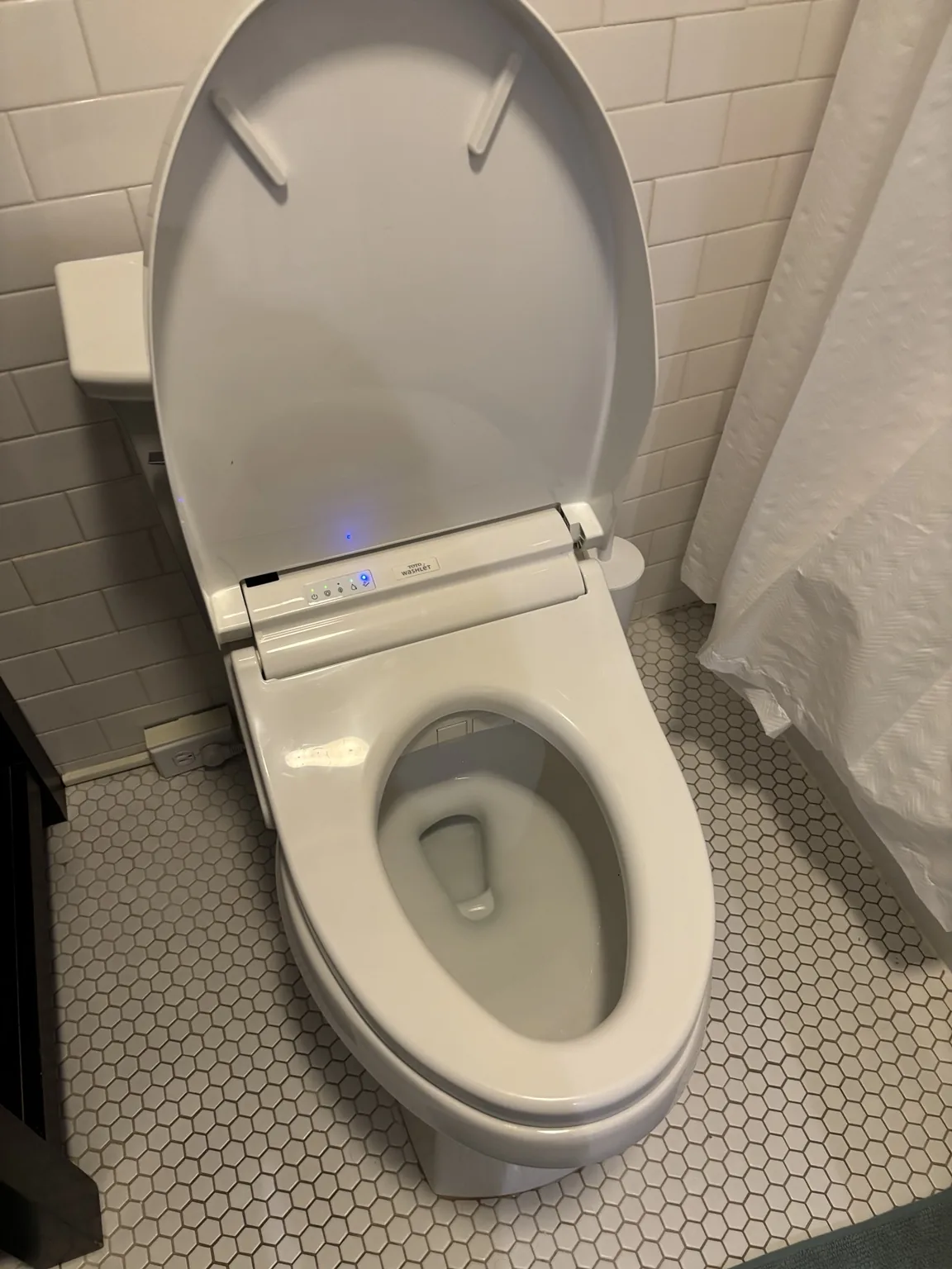 Real bathroom example showing an electric bidet seat setup where outlet planning matters